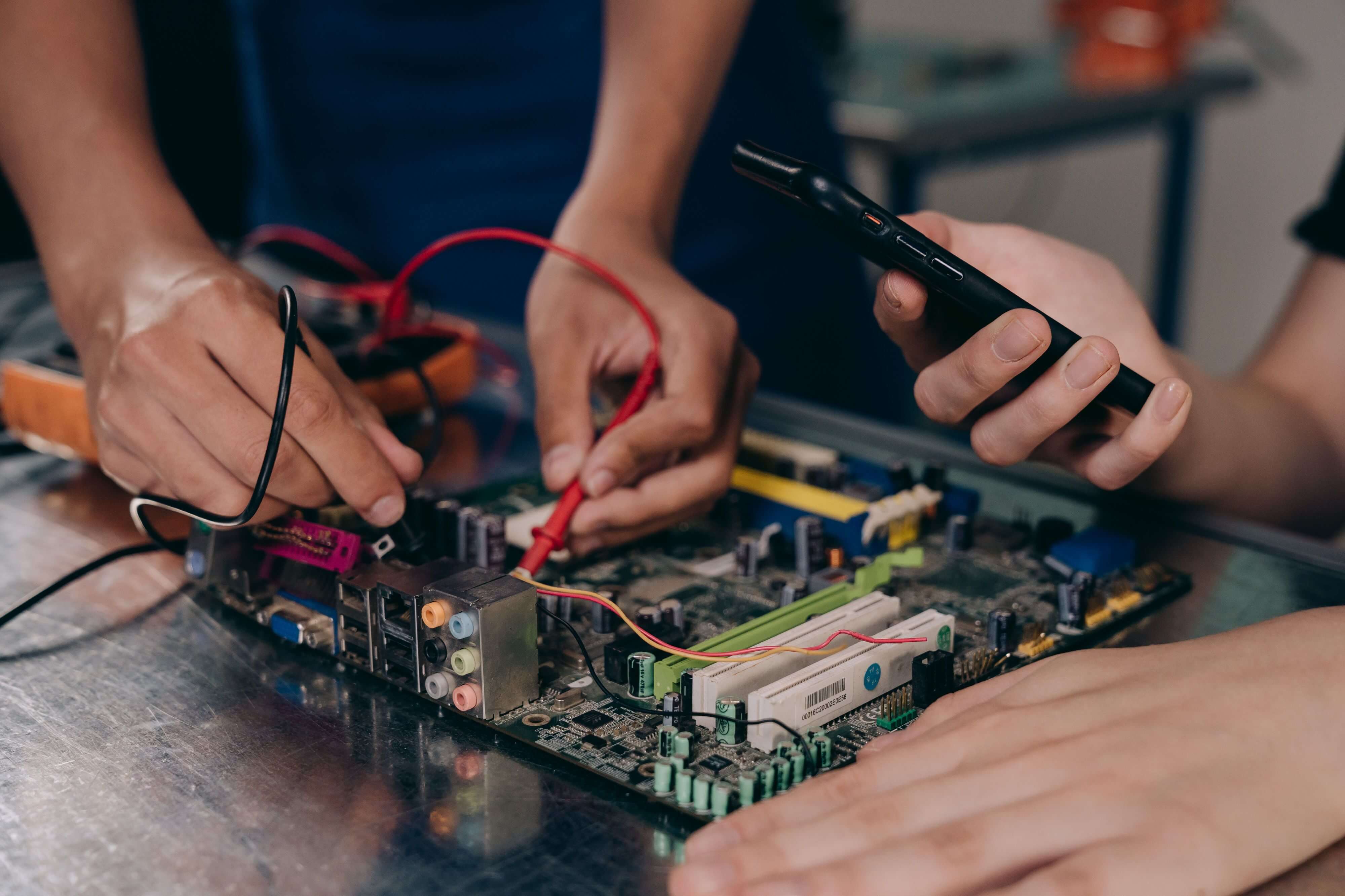 Comexa technicians working on electronic equipment